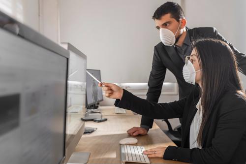 Office workers with face masks to prevent spread of the new coronavirus one pointing at screen with pen 2654 40189097 0 14145666 500